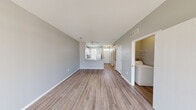 Located at 10325 Desmond Pl in Perrysburg, Ohio, this two-story, two-bedroom, two-bathroom home offers a well-organized layout spread evenly across two floors. The main level features an open-concept living and kitchen area with durable hardwood-style flooring throughout. The living room is highlighted by a corner fireplace with a classic white mantle, a built-in shelving nook, and a sliding glass door that fills the space with natural light and provides outdoor views. A ceiling fan adds to the comfort of the combined living area. The kitchen features white cabinetry, granite-style countertops, a stainless steel double sink, and a pass-through peninsula that connects it seamlessly to the living space. A convenient in-unit laundry room with full-size washer and dryer is also located on the main floor. Upstairs, two carpeted bedrooms offer a quiet retreat, with the primary bedroom boasting vaulted ceilings and generous proportions. Both bathrooms are finished with white cabinetry, granite-style countertops, and wood-style flooring; the upper bathroom features a double-sink vanity and a tub/shower combo. Soft gray tones throughout create a calm, cohesive ambiance in this move-in ready Perrysburg home.