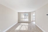 Located in Burtonsville, Maryland, this single-floor, 3-bedroom, 1-bathroom home offers a clean, neutral aesthetic throughout. The layout flows efficiently from a welcoming entry hallway into a spacious carpeted living room, where large windows invite generous natural light and provide views of the surrounding landscape. The updated kitchen is a functional highlight, featuring modern cabinetry in a warm taupe finish, stainless steel appliances including a refrigerator, electric range, and dishwasher, granite-look countertops, a classic subway tile backsplash, and light hardwood-style flooring. A pendant light and flush-mount ceiling fixture add a polished touch. The generously sized primary bedroom benefits from dual windows that bathe the room in natural light, while the additional bedrooms offer comfortable carpeted spaces with closet access. The bathroom is well-appointed with a large vanity mirror, multi-light fixture, white sink, and a tub-shower combination. Warm beige tones, white trim, and plush carpeting unify the interior, creating a cohesive and inviting atmosphere throughout this well-proportioned home.