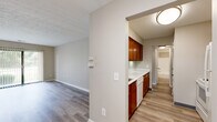 Located at 6870 E Livingstone Ave in Reynoldsburg, Ohio, this single-floor, 3-bedroom, 1-bathroom home offers a practical and well-organized layout. Wood-look laminate flooring runs consistently throughout the space, lending a cohesive and clean aesthetic to every room.

The entrance opens into a central hallway that connects the main living areas and bedrooms. The living area is bright and open, highlighted by a sliding glass door that provides direct access to an outdoor balcony and fills the room with natural light and greenery views.

The kitchen features warm-toned medium wood cabinetry — both upper and lower — paired with white countertops and a white dishwasher, creating a clean contrast. It opens conveniently toward the main living space, enhancing functionality.

All three bedrooms are carpeted with neutral-toned walls and feature louvered bi-fold closet doors with built-in hanging rods and shelving. The spacious primary bedroom offers ample room for furnishing. The secondary bedrooms are cozy and well-proportioned with their own closets.

The full bathroom includes a tub-shower combination with tiled surround, a white vanity, and light flooring, maintaining the home's clean, neutral palette. Textured ceilings are present throughout, adding a classic residential touch. The hallway provides seamless access to all rooms, keeping the floor plan efficient and easy to navigate.