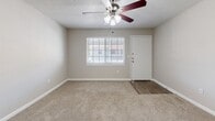 Located at 3706 W Idlewild Ave in Leto, FL, this single-floor, 2-bedroom, 2-bathroom home offers a practical and comfortable layout designed for everyday living. The open-concept living and kitchen area serves as the heart of the home, where plush wall-to-wall carpeting flows through the living space and a ceiling fan adds comfort overhead. Natural light enters through blinded windows, creating a bright and welcoming atmosphere. The kitchen features rich wood cabinetry, granite-style countertops, a peninsula breakfast bar, and stainless steel appliances including a refrigerator and dishwasher, complemented by hard surface flooring for easy maintenance. Both bedrooms are carpeted and well-lit, each equipped with ceiling fans and windows that invite natural light. The primary bedroom offers a generous footprint with ample closet storage. Three closets throughout the home provide abundant storage options. The two bathrooms are well-appointed with tile-surround tub/shower combos, granite-topped vanities, and wood-look flooring. A dedicated laundry area adds everyday convenience. Textured ceilings and neutral tones throughout give the home a clean, move-in-ready feel.
