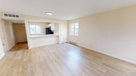 Located at 14 Darby Ct in New Hartford, NY, this single-floor, two-bedroom, two-bathroom residence offers a well-organized and functional layout. The open-concept living and kitchen area sets a welcoming tone, with light hardwood-style flooring that flows throughout the main living spaces and bright, neutral warm-beige walls that lend a clean, airy feel. Natural light filters in through multiple windows, enhancing the sense of openness.

The kitchen is outfitted with crisp white cabinetry, a peninsula countertop in white with an undermount sink, and black stainless appliances including a refrigerator, range, and over-the-range microwave. The peninsula opens directly to the living area, making it ideal for everyday functionality.

Both bedrooms are well-proportioned, with the primary bedroom offering a comfortable footprint and plush carpeted flooring. The second bedroom also features light hardwood-style flooring and a large window with views of the surrounding neighborhood. Both bathrooms are finished with wood-look flooring, and one includes a full soaking tub and shower combination with chrome fixtures.

A dedicated laundry area with washer/dryer hookups adds in-unit convenience, and baseboard heating is present throughout. This residence combines practicality with a clean, modern aesthetic.