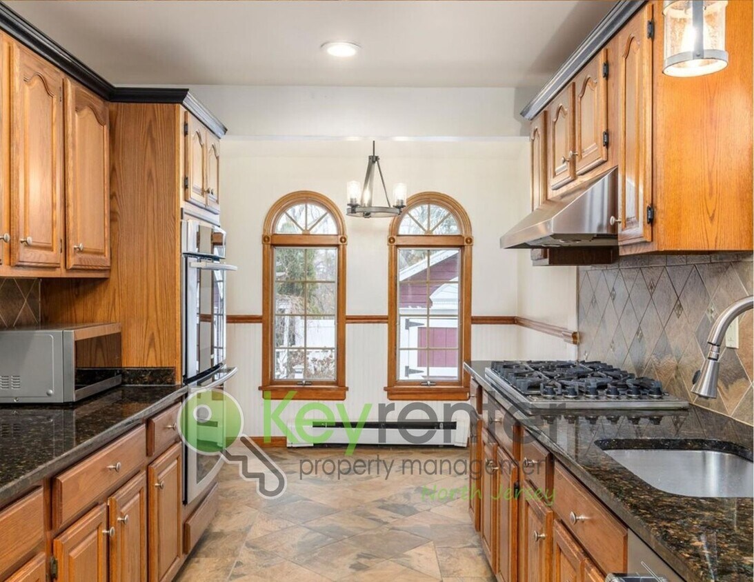 Primary Photo - Spacious 3-Bed, 2-Bath Nutley Home with Bonus Office, Multi-Level Deck & Quiet Location