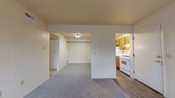 Located at 4206 Irish Hills Dr in South Bend, Indiana, this single-floor unit offers a practical and comfortable layout designed to maximize everyday functionality. The living area features neutral-toned carpet throughout, creating a warm and cohesive feel, and opens into an adjoining space that connects seamlessly to the rest of the unit. A large window with vertical blinds allows natural light to fill the main room, contributing to a bright and airy atmosphere.

The galley-style kitchen is efficiently designed with warm wood cabinetry lining both sides, white countertops, a double-basin stainless steel sink, and white appliances including a gas range and refrigerator. A louvered bifold door provides access to additional storage within the kitchen area, and the space features wood-look vinyl flooring for easy maintenance.

The bedrooms are carpeted and offer a clean, neutral palette, each equipped with louvered bifold closet doors for organized storage. One bedroom provides direct access to the entry door, offering added flexibility in how the space can be used.

The full bathroom includes a wood-vanity with a single sink, a mirrored medicine cabinet, and a white tub-shower combination, all finished with wood-look vinyl flooring that ties the space together. The overall layout is straightforward and well-connected, making this unit a functional and accessible living space.