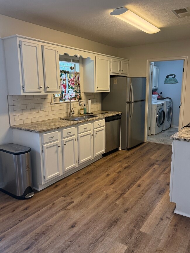Granite Countertops w/kitchen sink window looking out to backyard - 3 Jennifer Ct