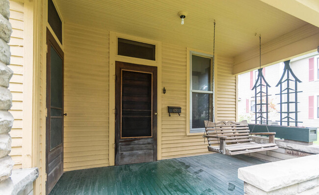 Inviting front porch with swing - 715 E 10th St