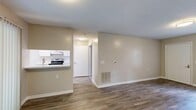 Located at 325 Forest Pine Rd in Franklin, Virginia, this single-floor, 2-bedroom, 2-bathroom home offers a clean and functional layout with a neutral color palette throughout. The living room features durable wood-look flooring, warm beige walls, and a textured ceiling, creating a bright and welcoming atmosphere. A window beside the front door allows natural light to fill the space. The kitchen is equipped with white cabinetry, light stone-look countertops, a stainless steel range, and an overhead ventilation hood. Light wood-look flooring and open shelving give the kitchen a practical, modern feel, with a hallway leading directly into the bedroom areas. Both bedrooms are finished with plush carpeting and textured ceilings. The spacious primary bedroom benefits from two windows, providing ample natural light and outdoor views. The second bedroom also includes a window overlooking the exterior. Each bathroom features a white vanity with under-cabinet storage, a mirrored medicine cabinet, and wood-look flooring. One bathroom includes a tub-shower combination, while the second bathroom is conveniently positioned adjacent to a bedroom. A hallway and closet complete the interior layout, offering practical storage and smooth circulation throughout the home.
