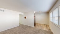 Located at 541 Wanamaker Road in Jenkintown, PA, this one-bedroom, one-bathroom unit offers a practical and comfortable single-floor layout. The living area features neutral-toned carpet and clean white walls, creating a bright and open atmosphere. A pass-through window connects the living space to the kitchen, adding a functional and classic architectural touch. Light hardwood-style flooring transitions seamlessly from the entryway into the kitchen and dining areas. The kitchen is well-equipped with rich dark wood cabinetry, a white subway tile backsplash, stainless steel appliances including a refrigerator, gas range, and dishwasher, along with light countertops that provide ample workspace. A window in the kitchen area allows for natural light and ventilation. The spacious primary bedroom features wall-to-wall carpet, crisp white walls, and a set of double sliding closet doors offering generous storage. A wide multi-panel window fills the room with natural light. The bathroom is finished with warm earth-toned tile flooring and tub surround, a white vanity with storage, a framed mirror, and a bright window. The overall aesthetic is clean, neutral, and move-in ready.