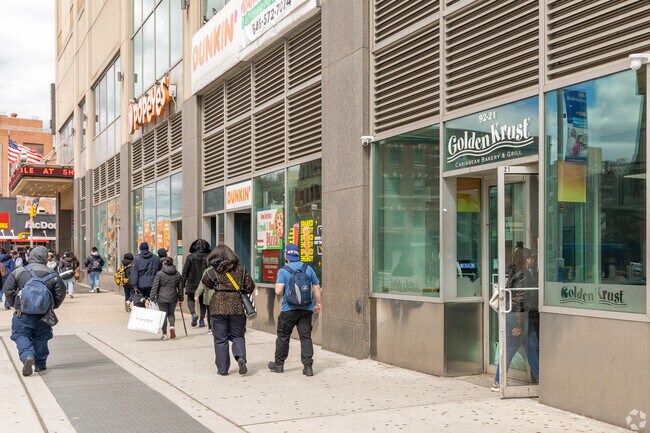 Shops and restaurants line busy sidewalks.