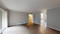 Located at 3524 Mount Diablo Blvd in Lafayette, CA, this single-floor residence offers a well-organized layout with a clean, neutral aesthetic throughout. The main living area features warm hardwood flooring, crown molding, a ceiling fan, and a large window that fills the space with natural light and views of the surrounding greenery.

The kitchen is outfitted with white cabinetry accented by matte black hardware, dark granite countertops, and a stainless steel range with overhead ventilation — a functional and stylish space for cooking and entertaining.

The bedrooms offer a mix of hardwood and plush carpet flooring. One bedroom includes mirrored sliding closet doors that enhance the sense of space, while a larger bedroom provides access to a dedicated walk-in closet area. Both rooms maintain the soft gray wall palette found throughout the home.

Two bathrooms serve the residence. One features a shower-tub combo with wood-look flooring, while the other includes a glass-enclosed walk-in shower — both finished with dark granite vanity countertops and brushed nickel fixtures. An in-unit laundry area adds everyday convenience. Crown molding, consistent finishes, and ample natural light lend the home a cohesive, well-maintained character throughout.