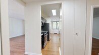Located at 380 Prospect Ave in Hackensack, NJ, this well-appointed one-bedroom, one-bathroom residence offers a thoughtfully organized layout across a single floor. Warm hardwood-style flooring flows consistently throughout, unifying the living, dining, and bedroom areas with a cohesive, inviting aesthetic.

The combined living and dining area is generously sized, featuring large sliding glass doors and multiple windows fitted with vertical blinds that fill the space with abundant natural light and provide views of the surrounding greenery. The galley-style kitchen is efficiently designed, outfitted with dark cabinetry, granite countertops, a stainless steel refrigerator, gas range, microwave, and dishwasher, all illuminated by overhead skylight-style lighting.

The spacious primary bedroom accommodates comfortable furnishing arrangements and includes a large built-in closet with bifold doors, complemented by a window that brings in natural light. In total, the unit features four closets, providing excellent storage throughout. The bathroom is finished with large-format neutral tile surrounding a soaking tub and shower combination, offering a clean, modern look.

A hallway connects the main living spaces and provides access to additional closet storage, enhancing the unit's overall functionality. The layout is practical and well-suited for everyday living.