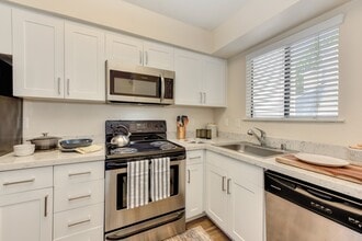 Kitchen with White Cabinets - Silverstone Apartments