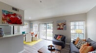 This one-bedroom, one-bathroom residence in Houston, TX offers a thoughtfully designed single-story layout that balances comfort and functionality. The open-concept living and dining area is finished with wood-style plank flooring, crown molding, and neutral gray walls that create a clean, contemporary backdrop. Large sliding glass doors and multiple windows allow generous natural light to fill the space while providing outdoor views. The living room offers ample room for seating and entertaining, flowing seamlessly into the dining area.

The kitchen features white shaker-style cabinetry with brushed hardware, stone-look countertops, a stainless steel undermount sink, and stainless steel appliances including a refrigerator, oven, and built-in microwave. A pass-through opening connects the kitchen to the living area, enhancing the open feel.

The bedroom is carpeted for comfort and includes multiple windows, a ceiling fan, and direct access to an outdoor patio. A spacious walk-in closet provides ample storage. The full bathroom is well-appointed with white cabinetry, stone-look countertops, a large mirror, and wood-style flooring, maintaining the cohesive, modern aesthetic found throughout the home.