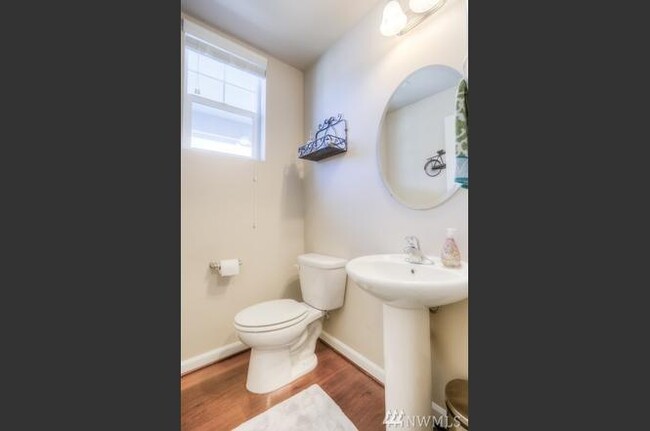 Powder room downstairs, near front door, and garage door entry - 8828 Jayden Ln NE
