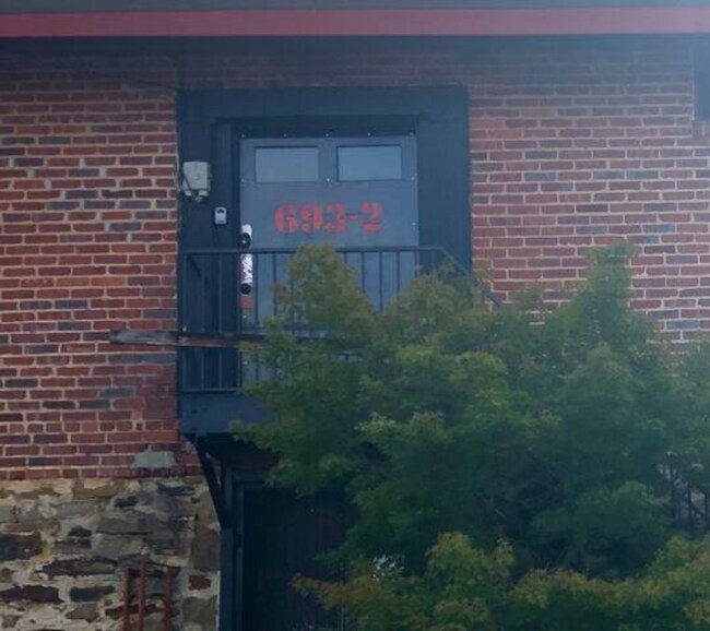 View of the entrance to loft from the parking lot. - 693 W North St