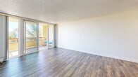 Located at 1801 Shore Line Dr in Alameda, California, this 2-bedroom, 1-bathroom residence offers a well-organized layout across a single floor. The combined living and dining area is bright and open, featuring wood-style plank flooring, crown molding, and a textured ceiling. Sliding glass doors lead to a private balcony, flooding the space with natural light and offering pleasant outdoor views of the surrounding greenery.

The kitchen is thoughtfully appointed with warm honey-toned cabinetry, dark marbled stone countertops, a classic white subway tile backsplash, and a double stainless steel sink — providing both functionality and style.

Both bedrooms are carpeted for comfort and receive ample natural light through large windows that frame outdoor views. The primary bedroom includes access to a dedicated closet. A second bedroom features hardwood-style flooring and a ceiling fan, adding versatility to the space.

The bathroom is finished with wood-accent wall paneling, a wide vanity with gray countertops, white cabinetry, and a framed mirror — creating a clean, contemporary feel. Wood-style flooring continues throughout the bathroom, tying the design together cohesively. Overall, the residence presents a comfortable and practical living environment in a desirable Alameda waterfront location.