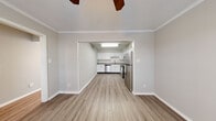 Located at 221 E Main St in Carmel, Indiana, this two-story home offers three bedrooms and two bathrooms thoughtfully distributed across two floors. The main level features an open living area that flows directly into a well-equipped kitchen, highlighted by crisp white cabinetry, granite-style countertops, a subway tile backsplash, and a full suite of stainless steel appliances. Light wood-style flooring runs throughout the main level, complemented by crown molding and ceiling fans that add a classic touch. A bright hallway on the main floor leads to a dedicated laundry area with a full-size washer and dryer. Upstairs, the three bedrooms are carpeted for comfort, each featuring ceiling fans and ample natural light. The generously sized primary bedroom includes both a walk-in closet and an additional closet with louvered bifold doors. The bathrooms are finished with granite-topped vanities and full tub-shower combinations. A carpeted staircase with a white-painted banister and decorative iron spindles connects the two floors with a charming touch. Two hallways and two closets round out the practical layout, making this home well-suited for everyday living in a prime Carmel location.