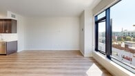 Located at 777 Tennessee Street in San Francisco's Potrero Hill neighborhood, this one-bedroom, one-bathroom unit offers a well-appointed, single-level layout with a clean, contemporary design aesthetic. The open-concept living and kitchen area forms the heart of the unit, where light wood-tone flooring runs throughout, complemented by crisp white walls that enhance the sense of brightness and space.

The kitchen is a standout feature, equipped with dark espresso cabinetry, a white subway tile backsplash, granite countertops, and a full suite of stainless steel appliances including a gas range, built-in microwave, dishwasher, and French door refrigerator. A generous kitchen island provides additional prep and storage space, flowing seamlessly into the living area. Large floor-to-ceiling windows flood the living room with natural light and offer views of the surrounding San Francisco streetscape.

The bedroom is a comfortably sized, carpeted room with a dedicated window providing natural light and neighborhood views. A closet offers practical storage. The bathroom features large-format tile flooring, a dark wood vanity with a stone countertop, and a full tub-shower combination with classic subway tile surround. The unit's modern finishes and efficient layout make it a functional and attractive urban residence.