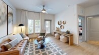 Located at 962 Mabry Hood Rd in Knoxville, TN, this thoughtfully designed 2-bedroom, 2-bathroom residence offers a comfortable and modern living experience across a single level. The open-concept kitchen and living area serves as the heart of the home, where light wood-tone flooring flows throughout. The kitchen is outfitted with two-tone cabinetry — crisp white uppers paired with slate gray lowers — stainless steel appliances, a subway tile backsplash, pendant lighting, and a large island with seating, ideal for dining and entertaining. The living room is bright and airy, with large windows and a glass door opening to a private balcony, a ceiling fan overhead, and abundant natural light. Both bedrooms are generously sized, each featuring ceiling fans, large windows with exterior views, and dedicated walk-in closets with wire shelving systems for organized storage. The primary bathroom features a dual-sink vanity with gray cabinetry and wood-look flooring, while the second bathroom includes a single vanity and a full soaking tub. Each bathroom connects directly to its respective walk-in closet. The overall aesthetic is clean and contemporary, with neutral tones throughout creating a calm, cohesive ambiance.