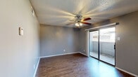 Located at 696 Fox Ave in Lewisville, TX, this single-floor, one-bedroom unit offers a thoughtfully laid-out interior with consistent wood-look flooring throughout. The open living area is bright and airy, featuring a ceiling fan with light fixture, neutral gray walls, a textured popcorn ceiling, and a sliding glass door that opens to a private balcony — bringing in ample natural light and outdoor views. A structural column defines the transition between the living space and the rest of the unit, adding a distinctive architectural element.

The kitchen is a standout feature, showcasing rich dark espresso cabinetry, light granite-style countertops, a mosaic tile backsplash, and black appliances including a range and dishwasher. A window above the sink provides natural light, while a pantry offers additional storage convenience.

The spacious primary bedroom comfortably accommodates large furniture, with its own ceiling fan, natural light from a window, and direct access to a dedicated closet. Neutral gray walls and wood-look flooring carry throughout, creating a cohesive and clean aesthetic. The overall ambiance is modern and functional, making this a well-equipped unit in Lewisville.