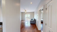 Located at 1115 Ashland Road in Columbia, Missouri, this well-appointed two-bedroom, two-bathroom residence offers a thoughtfully designed single-level layout. Rich hardwood flooring flows throughout the main living areas and bedrooms, creating a warm and cohesive aesthetic.

The open-concept living room is spacious and bright, featuring recessed lighting, a ceiling fan, and a large window that invites natural light. It connects seamlessly to the galley-style kitchen, which is equipped with warm wood cabinetry, dark granite countertops, stainless steel appliances including a refrigerator and electric range with microwave, and tile flooring.

Both bathrooms echo the kitchen's design language, featuring matching granite-topped vanities with wood cabinetry and tile floors. One bathroom includes a full shower/tub combo with brushed nickel fixtures, while the other offers a walk-in shower area.

The primary bedroom is a comfortable, well-sized retreat with hardwood floors, a ceiling fan, and direct access to a hallway leading to the bathroom. The second bedroom is equally inviting, with a window overlooking greenery and its own ceiling fan. Additional utility space and a hallway complete the functional layout, making this a practical and polished residence.