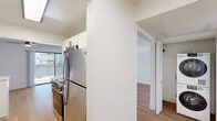 Located at 444 Saratoga Ave in Santa Clara, CA, this single-story 1-bedroom, 1-bathroom unit offers a thoughtfully designed layout across a comfortable footprint. The open living room is bright and airy, featuring light hardwood-style flooring, a ceiling fan, and large sliding glass doors that fill the space with natural light and provide direct access to a private outdoor patio, offering pleasant views of surrounding greenery.

The kitchen is well-appointed with white shaker-style cabinetry, black hardware accents, white quartz countertops, a black undermount sink, and a full suite of stainless steel appliances. The same warm hardwood-style flooring continues throughout, creating a cohesive feel.

The spacious primary bedroom is carpeted for comfort, features a large sliding closet, and includes a wide window that invites natural light and outdoor views. The hallway connecting the main living areas leads to a clean, modern bathroom outfitted with white cabinetry, a large vanity mirror, and a well-lit vanity with black fixtures — all complemented by the same warm hardwood-style flooring. The unit presents a clean, neutral palette throughout, making it move-in ready and easy to personalize.