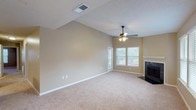 Located at 7827 Jefferson Place Cir in Baton Rouge, Louisiana, this single-story home offers a well-designed layout with comfortable living spaces throughout. The living room serves as a central highlight, featuring soaring vaulted ceilings, soft carpet flooring, a ceiling fan with light fixture, and a classic fireplace with a white mantle. Natural light filters in through multiple windows, creating a bright and airy atmosphere. An exterior door provides convenient access from the living area.

The kitchen is equipped with stainless steel appliances, including a range, microwave, and refrigerator, all complemented by crisp white cabinetry, light countertops, and warm wood-look flooring. Ample cabinet storage makes this kitchen both functional and visually clean.

The bedrooms are generously proportioned, each featuring plush carpet flooring, ceiling fans with light kits, and windows that allow in natural light. The rooms are finished in warm neutral tones throughout, providing a cohesive and welcoming feel.

The bathroom includes a double-sink vanity with white cabinetry and light countertops, a large mirror, wood-look flooring, and a tub-shower combination with white tile surround. The textured ceilings are consistent throughout the home, adding a classic residential character to each space.