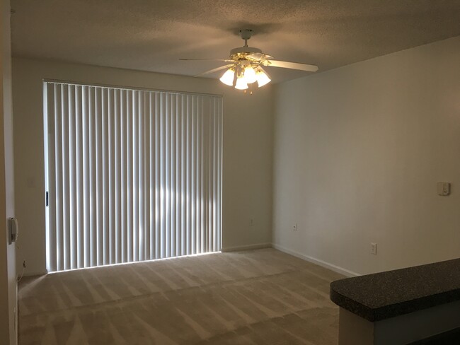 Building Photo - Great first floor corner unit, gated commu...