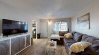 Located at 902 Greenland Dr in Murfreesboro, TN, this single-floor unit offers 2 bedrooms and 2 bathrooms within a compact, efficiently arranged layout. The living room serves as the central gathering space, featuring wood-look flooring, a textured ceiling, and a front-facing window that allows natural light to filter in. The open sightlines from the living area connect easily to the kitchen, which is equipped with dark cabinetry, granite-style countertops, a stainless sink, and black appliances including an electric range and over-the-range microwave. The primary bedroom is a comfortable retreat with neutral-toned walls, wood-look flooring, a closet, and a window for natural light. The second bedroom offers a similar aesthetic — warm, neutral walls, wood-look floors, and a closet — making it well-suited as a guest room or home office. Both bathrooms are clean and functional, with one featuring a shower-tub combination. Additional spaces include a utility room and two closets for storage. Throughout the unit, consistent wood-look flooring and a light, neutral color palette create a cohesive and welcoming atmosphere.