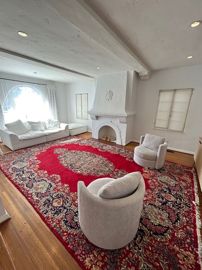 Large living room with multiple windows - 8673 W Olympic Blvd
