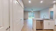 Located at 11305 Grant Rd in Houston, TX, this single-story, 2-bedroom, 2-bathroom home offers a thoughtfully designed layout with modern finishes throughout. Light wood flooring flows seamlessly across the entire space, creating a bright and cohesive aesthetic.

The kitchen serves as a standout feature, showcasing crisp white shaker cabinetry, a subway tile backsplash, granite countertops, and a full suite of stainless steel appliances including a gas range, microwave, dishwasher, and side-by-side refrigerator. A central island with an undermount sink adds both functionality and style.

The living area is generously proportioned, bathed in natural light from large sliding glass doors that open to an outdoor patio and green lawn — ideal for indoor-outdoor living. Ceiling fans are present throughout.

Both bedrooms are well-sized, each featuring large windows with blinds that invite natural light, and ceiling fans for year-round comfort. Two closets provide ample storage, including a walk-in closet with wire shelving systems.

The two bathrooms are finished with granite-topped white vanities and wood-look flooring. One bathroom features a tiled tub-shower combo, while the other includes a glass-enclosed walk-in shower, offering versatility for residents.