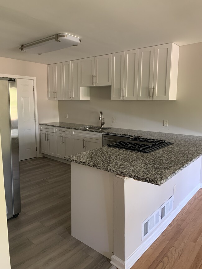 Spacious, open kitchen recently renovated with stainless appliances. Room for bar stools. - 561 Northern Ave