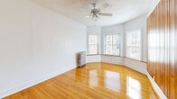 Located on S Crandon Ave in Chicago's South Side, this well-appointed 1-bedroom, 1-bathroom unit offers a thoughtful layout across a single floor. Warm hardwood floors run throughout the living areas and bedroom, lending a timeless character to the space. The living room is a standout feature, boasting a beautiful bay window configuration that draws in generous natural light and a ceiling fan overhead, while classic cast-iron radiators add a charming vintage touch seen throughout the unit. A separate dining room connects seamlessly to the living area, creating a natural flow for everyday living. The bedroom features its own window with neighborhood views, a ceiling fan, and the convenience of two closets — one of four total closets found throughout the unit. The kitchen has been tastefully updated with sage-green shaker-style cabinetry, marble-look countertops, a mosaic tile backsplash, and black appliances including a gas range and refrigerator, all set on durable plank flooring. The bathroom features neutral stone-look tile surrounding the bathtub, complemented by a bright window. A dedicated entrance and hallway complete the layout, offering a practical and well-organized flow throughout this classic Chicago residence.