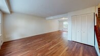Located at Colonial Terrace in Plymouth, Massachusetts, this two-floor residence offers a well-organized and functional layout across both levels. The main floor greets residents with a bright entryway featuring tile flooring that transitions into warm hardwood floors extending through the living and dining areas. A staircase with a classic wooden banister connects the floors, and windows along the front of the home allow natural light to fill the space. The kitchen is equipped with rich wood cabinetry, granite countertops, black appliances including a gas range, dishwasher, and built-in microwave, complemented by hardwood flooring and a door providing exterior access. The upper floor features multiple carpeted bedrooms, each with windows that frame views of surrounding trees or the neighborhood streetscape. One bedroom offers dual bifold closets alongside an additional separate closet, providing generous storage. The bathroom is finished with white subway tile wainscoting, tile flooring, a window for natural ventilation, and brushed brass hardware accents. Throughout the residence, neutral wall tones, clean white trim, and consistent flooring choices create a cohesive and move-in-ready environment suited for comfortable everyday living.