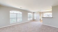 Located at 950 S Cimarron Way in Aurora, Colorado, this single-floor, three-bedroom, two-bathroom home offers a well-designed layout with comfortable living spaces throughout. The open living room is a standout, featuring distinctive arched windows that flood the room with natural light and offer views of the surrounding greenery. Neutral-toned carpet and crown molding add a polished finish to the space, which flows seamlessly into the kitchen. The kitchen is equipped with warm honey-toned cabinetry, white appliances, a built-in microwave, and a peninsula island topped with granite countertops — ideal for both cooking and casual dining. Hardwood-style flooring anchors the kitchen and extends into the laundry room, which accommodates a full-size washer and dryer side by side. The three bedrooms are carpeted and well-lit, each featuring ceiling fans and windows with outdoor views. The primary bedroom offers a generous footprint with ample room for furnishings. The bathrooms include a tiled tub-shower combo with brushed nickel fixtures. Two closets provide additional storage. A central hallway connects the private quarters, completing the functional and cohesive floor plan of this Aurora home.