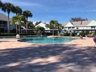 Community pool with resort swim and separate lap swim areas. - 181 Grand Oaks Way