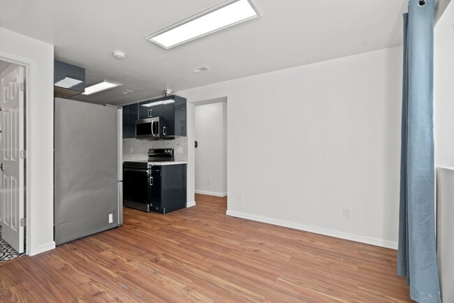 Open-concept renovated modern kitchen with all new stainless steel appliances - 411 124th St S