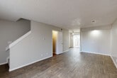 Located at 3324 S Field St in Lakewood, Colorado, this two-story home offers three bedrooms, two bathrooms, and a thoughtfully arranged layout spread across two floors. The main level features an open living and dining area with durable wood-look flooring, neutral gray walls, and a textured ceiling throughout. A ceiling fan accents the living area, which receives natural light through a sliding glass door fitted with vertical blinds. The galley-style kitchen is well-appointed with white shaker cabinetry, marble-look countertops, a gray subway tile backsplash, stainless steel appliances including a refrigerator and dishwasher, and a double-basin sink — all set over wood-look flooring. A staircase connects the main level to the upper floor, where three bedrooms are located. The bedrooms feature plush carpeting, neutral tones, and windows that bring in natural light. The primary bedroom is a comfortable, well-sized retreat. Both bathrooms include a tub-shower combination with clean white tile surround. The home's consistent use of neutral finishes, wood-look flooring on the main level, and carpet in the bedrooms creates a cohesive and move-in-ready aesthetic throughout.
