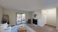 Located at 5669 N Fresno St in Fresno, CA, this single-story 2-bedroom, 2-bathroom residence offers a well-organized and comfortable layout across a efficiently utilized floor plan. The living room serves as the heart of the home, featuring a tile-surround fireplace and sliding glass doors that open directly onto a private patio, allowing for natural light and outdoor views. The adjacent dining area is set on hardwood-style flooring and is equipped with a ceiling fan, creating a distinct and functional space for meals. The galley-style kitchen offers ample white cabinetry, generous counter space, a gas range, and a double-basin sink — all finished in a clean, bright aesthetic. Both bedrooms are carpeted and generously proportioned, with the primary bedroom offering a ceiling fan and a window with outdoor views, along with closet storage. A second bedroom is also well-sized with closet access. The two bathrooms are finished in white with hardwood-style flooring, vanities, and tub-shower combinations. Throughout the residence, neutral wall tones and textured ceilings contribute to a cohesive, understated ambiance. Additional features include a utility room, hallway, and multiple closets for ample storage.