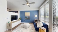Located at 355 N Rosalind Ave in the heart of Orlando, FL, this one-bedroom, one-bathroom unit offers a thoughtfully designed single-floor layout that maximizes every square foot. The living room immediately draws attention with its bold navy blue accent wall, ceiling fan with integrated lighting, wood-look flooring, and large windows fitted with blinds that allow for adjustable natural light. A built-in media console with white cabinetry adds both style and function to the space. The kitchen is outfitted with dark cabinetry, light countertops, a subway tile backsplash, and a full suite of stainless steel appliances including a refrigerator, range, microwave, and dishwasher, all illuminated by track lighting overhead. The hallway connects the main living areas to the private quarters, featuring a sliding barn-style door that adds a modern touch. The bedroom continues the navy accent wall theme, complemented by carpet flooring, a walk-in closet with wire shelving, and direct access to a utility area. The bathroom features a dark vanity with a white sink, wood-look tile flooring, and a glass-enclosed walk-in shower adorned with decorative tile accents. In-unit laundry access completes this well-appointed and efficiently laid-out home.