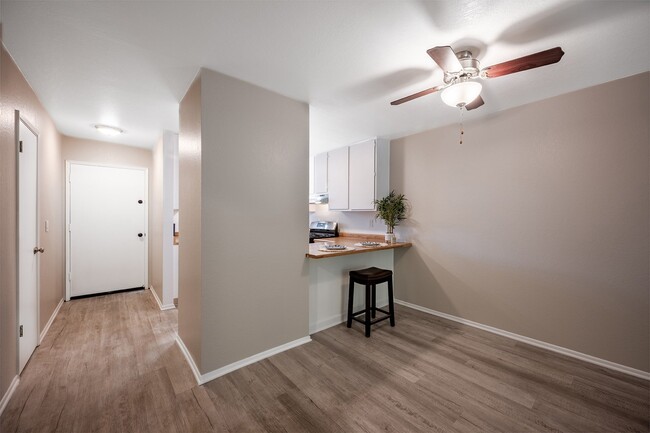 sala y cocina con ventilador de techo - Oak Park Apartments