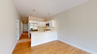 Located at 441 W Main St in Cary, Illinois, this single-floor, 3-bedroom, 2-bathroom home offers a clean, modern aesthetic with thoughtful finishes throughout. The open-concept kitchen and living area serves as the heart of the home, featuring white shaker-style cabinetry, stainless steel appliances including a gas range, over-the-range microwave, and French door refrigerator, all complemented by light quartz countertops and a peninsula with a built-in sink — ideal for casual dining or entertaining. Warm hardwood-style flooring flows seamlessly through the living areas and down a bright, well-lit hallway connecting the three bedrooms and two bathrooms. The primary bedroom offers a generously sized and comfortable retreat. The bathrooms are finished in a contemporary style, with one featuring a floating wood-toned vanity, white countertop, and wood-look tile flooring. Two closets provide practical storage solutions throughout the home. The interior palette of crisp white walls and neutral tones creates a light, airy ambiance across all rooms. Recessed lighting in the kitchen and ceiling fixtures in the bedrooms ensure well-lit spaces throughout. The hallway, leading toward a windowed exterior door, hints at outdoor access, rounding out this functional and attractively designed home.