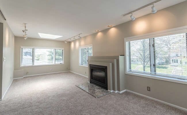 Spacious living room with gas fireplace (South and West facing sunlight). - 4105 Upton Ave S