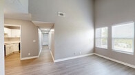 Located at 488 Lemont Dr in Nashville, TN, this single-story, 3-bedroom, 3-bathroom home offers a well-designed layout with modern updates throughout. The living area immediately impresses with soaring vaulted ceilings and light wood-look flooring, creating an open and airy atmosphere. Large windows allow natural light to flood the space, enhancing the neutral gray-toned walls and clean white trim throughout.

The kitchen is well-appointed with crisp white shaker cabinets, light quartz countertops, a classic subway tile backsplash, and stainless steel appliances, including an electric range with an over-the-range microwave. Light wood-look flooring continues through this space, adding warmth and cohesion.

Each of the three bedrooms features soft carpeting, ceiling fans, and windows that bring in natural light. The primary bedroom includes a dedicated walk-in closet with dual hanging rods and shelving. Additional bedrooms offer ample space and closet storage.

The bathrooms are thoughtfully finished with light wood-look flooring, white vanity cabinetry with subway tile accents, and brushed nickel fixtures. At least one bathroom features a full soaking tub with large-format tile surround. Two hallways connect the rooms, providing a smooth and practical flow throughout this well-maintained Nashville home.