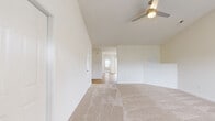 Located at 10015 Parthenon Court in Charlotte, NC, this single-story, 4-bedroom, 2-bathroom home offers a well-designed layout with a bright, neutral palette throughout. The living room greets you at the entry with vaulted ceilings, a ceiling fan, and a front-facing window that brings in natural light, complemented by plush wall-to-wall carpeting. The kitchen is a functional highlight, featuring white shaker-style cabinetry, a classic subway tile backsplash, stainless steel appliances including a range and microwave, and light hardwood-style flooring. A sliding glass door adjacent to the kitchen provides outdoor access and additional natural light. The four bedrooms are carpeted and generously sized, with the primary bedroom offering vaulted ceilings, a ceiling fan, and ample space. Several bedrooms include double-door closets for practical storage. The two bathrooms are finished with white cabinetry, marble-style countertops, brushed nickel hardware, and hardwood-style flooring. One bathroom features a dedicated vanity area, while the second includes a full tub-shower combination. A connecting hallway ties the layout together efficiently, making this home comfortable and easy to navigate.