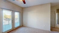Located at 601 Giddings Court in Augusta, Georgia, this single-story, three-bedroom, two-bathroom home offers a well-organized and functional layout. The kitchen is a standout feature, showcasing rich dark wood cabinetry, dark countertops, black appliances, and a breakfast peninsula that opens to the living area — all illuminated by track lighting overhead. The seamless flow between the kitchen and living space creates an inviting, open feel underfoot with plush carpeting throughout.

The generously sized primary bedroom includes crown molding, a ceiling fan, natural light from a large window, and access to a spacious walk-in closet outfitted with wire shelving and hanging rods for ample storage. The two additional bedrooms are equally well-appointed, each featuring carpeted floors, ceiling fans, and windows that bring in natural light. The bathrooms are finished with dark wood vanities, gray countertops, and tile flooring for a clean, cohesive aesthetic.

A dedicated laundry room provides washer and dryer hookups along with overhead wire shelving and tile flooring, adding practical convenience. Three total closets across the home ensure excellent storage throughout. The thoughtful single-floor layout makes this home both accessible and efficient.