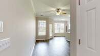 Located at 5504 Town Center Dr in Mishawaka, Indiana, this well-appointed single-floor residence offers two bedrooms, two bathrooms, a dedicated office, and in-unit laundry within a thoughtfully designed floor plan. The open-concept living room and kitchen area is anchored by warm wood-look flooring, crown molding, and a ceiling fan, with multiple windows that invite generous natural light and outdoor views. The kitchen features white cabinetry, light quartz countertops, a double stainless steel sink, and stainless steel appliances, including a refrigerator, range, and dishwasher. The bedrooms are finished with plush carpeting and windows with blinds, offering a comfortable retreat. One bathroom includes a tub-shower combination with a white vanity and quartz countertop, while the second bathroom features a sliding glass-door shower enclosure with matching finishes. The dedicated office is equipped with a built-in corner desk and floating shelves, making it a highly functional workspace. The in-unit laundry room accommodates a full-size washer and dryer with additional shelving for storage. Wood-look flooring runs throughout the non-carpeted areas, contributing to a cohesive and clean aesthetic across the entire residence.