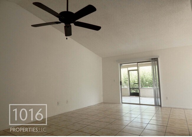Living room opening to lanai - 4755 White Willow Ln