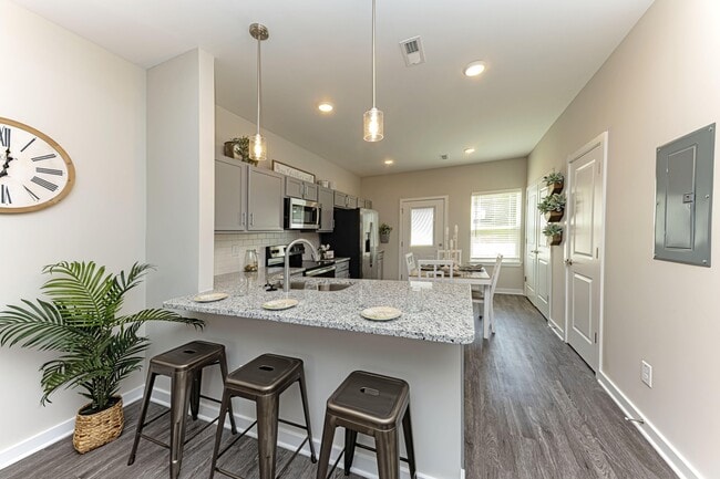 Kitchen with granite counters, stainless appliances, and modern cabinetry - Sango Ridge