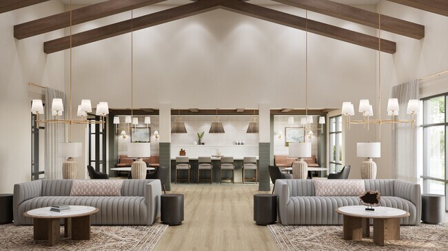 Amplia casa club con techo abovedado, luces colgantes, asientos tipo lounge y una cocina comunitaria con barra y decoración. - Oakwood Trails