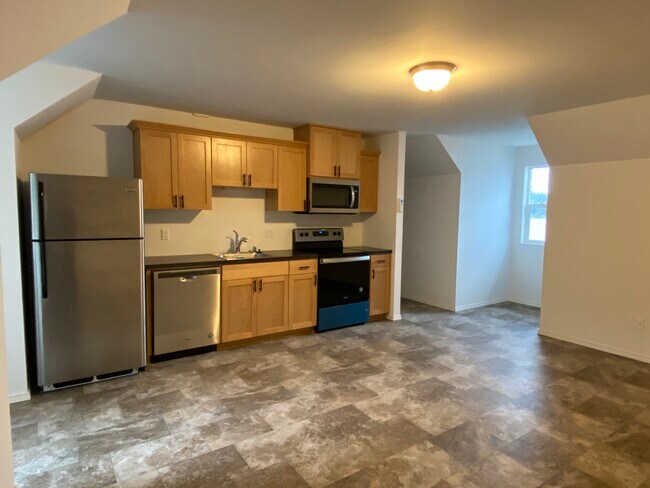 View of kitchen and living room has bay window to Lake view - 1090 Kitsap Lake Rd NW